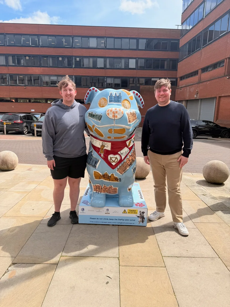 Danny and Ethan out in Stafford, beside a painted Staffordshire bull terrier sculpture